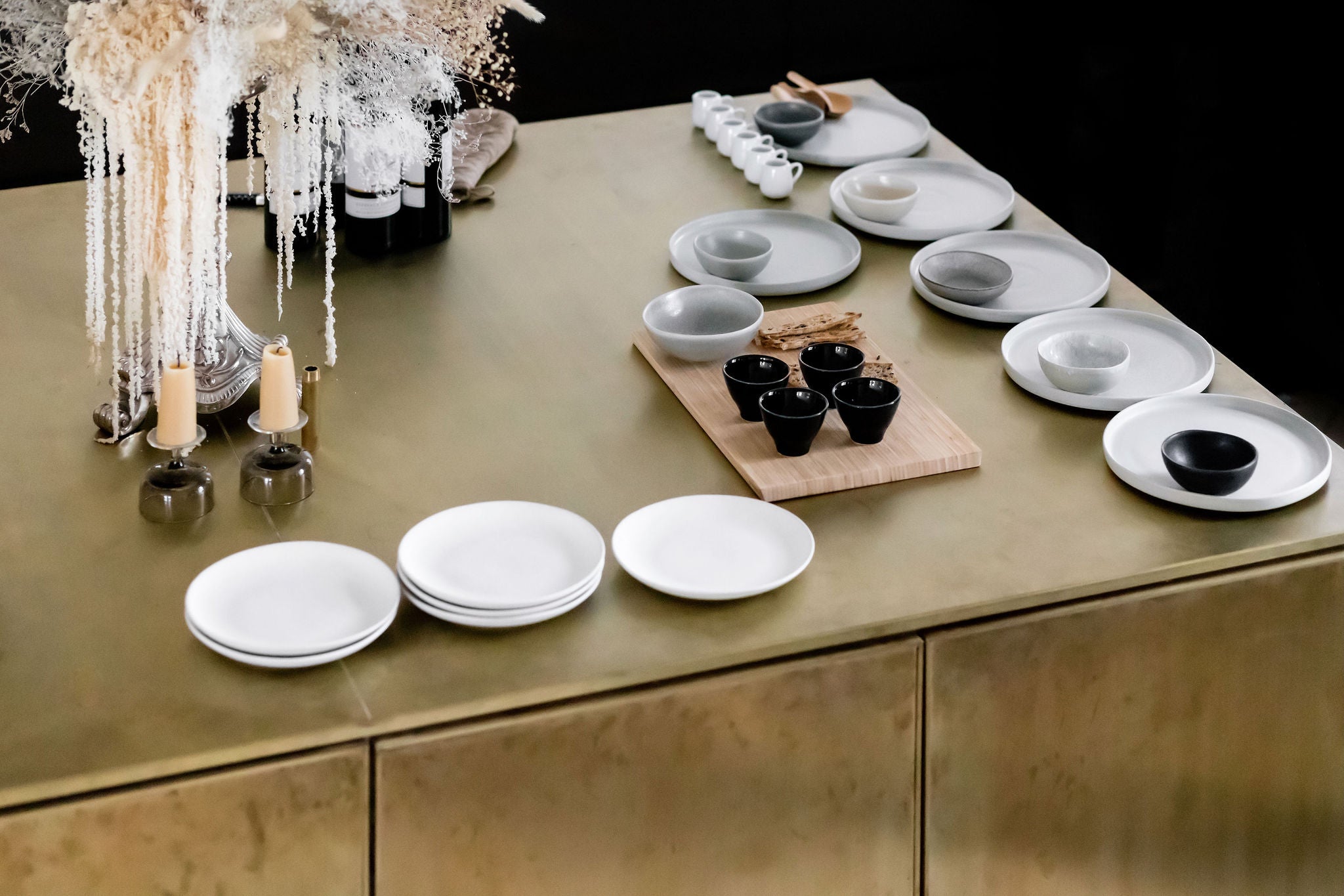 a series of dishes arranged on a brass countertop