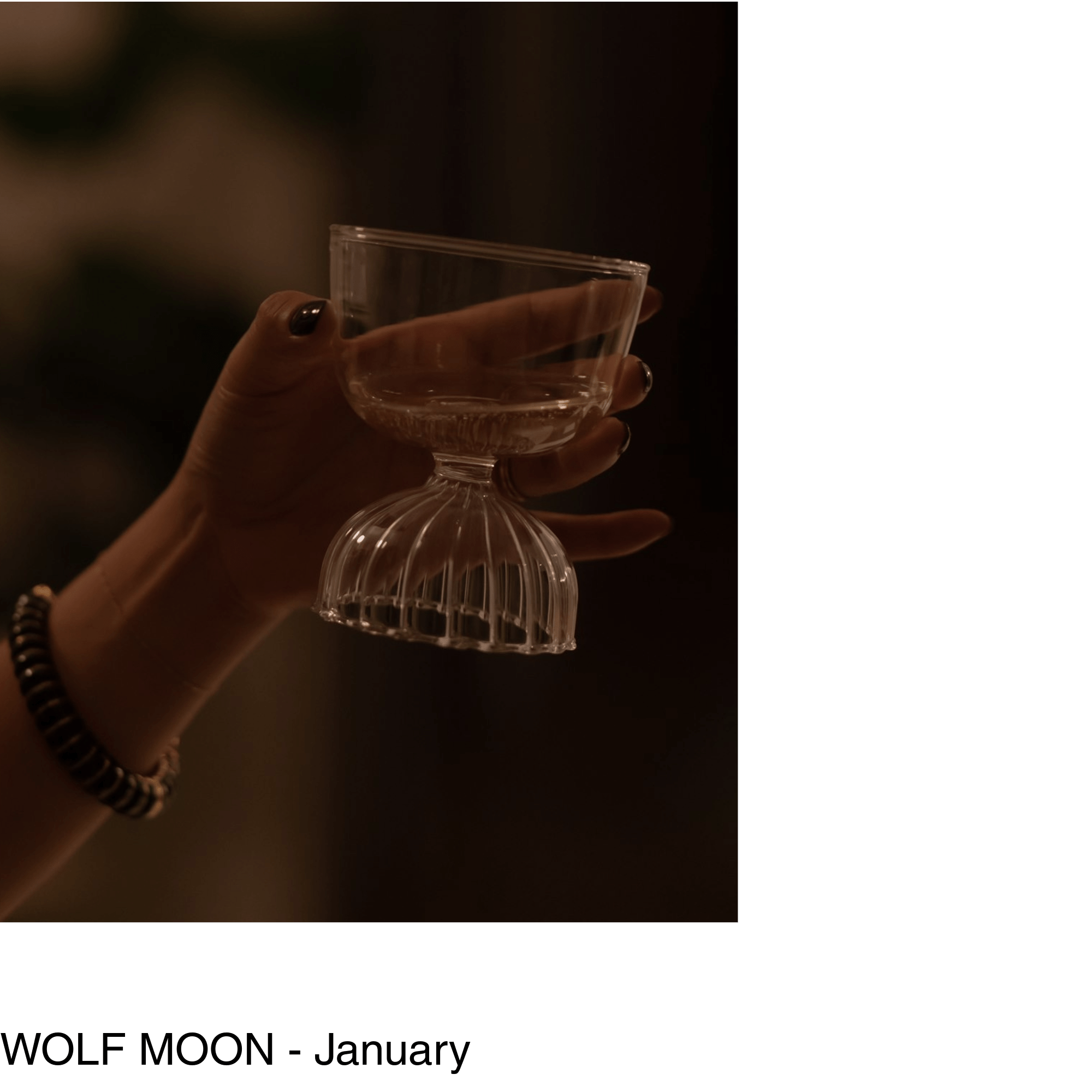 a hand holds a glass of white wine