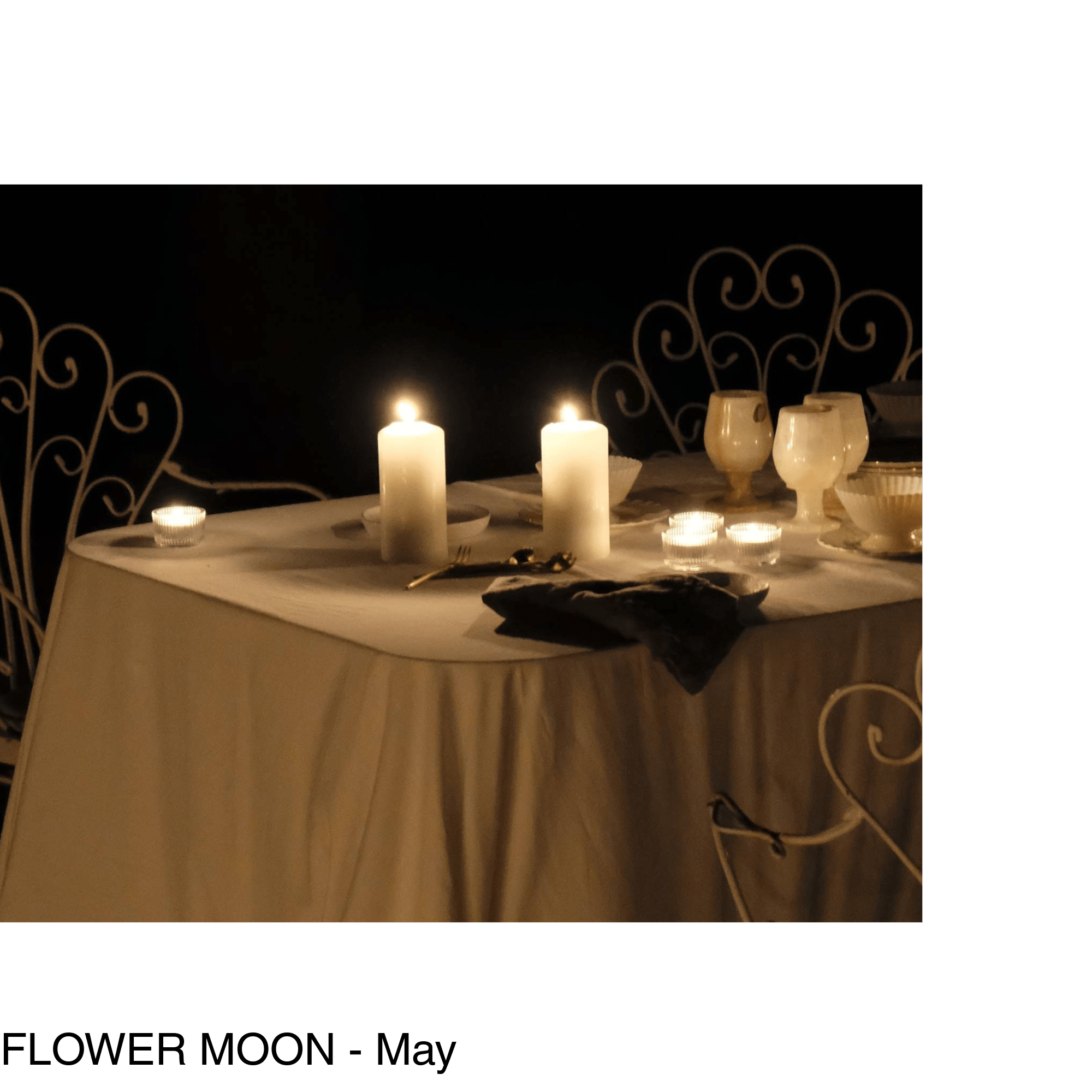 two pillar candles sit in the middle of a table in the moonlight