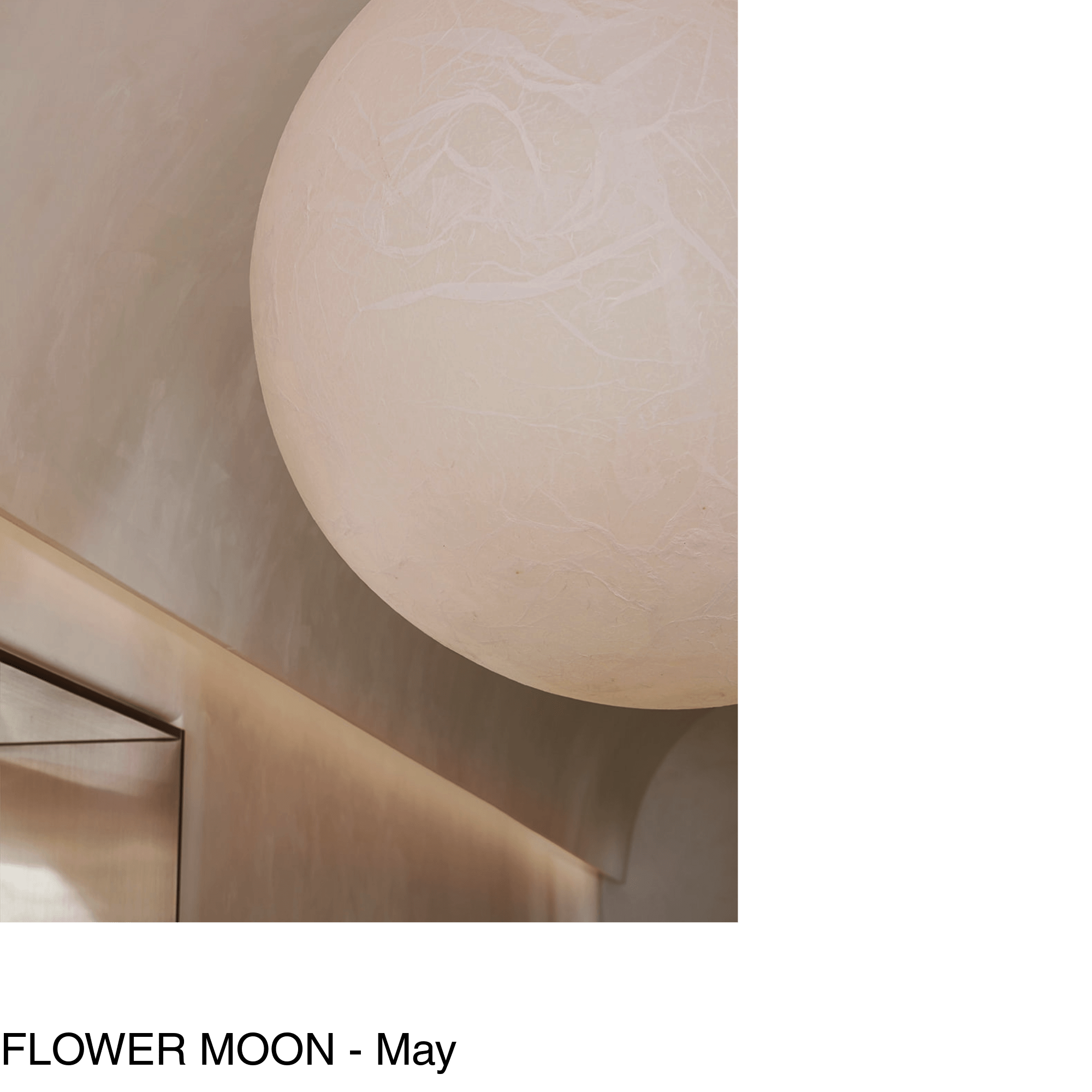 a large moon shaped pendant hangs in a hallway