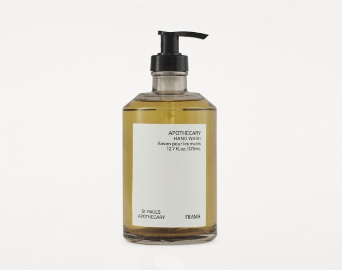 yellow coloured hand wash in clear glass bottle