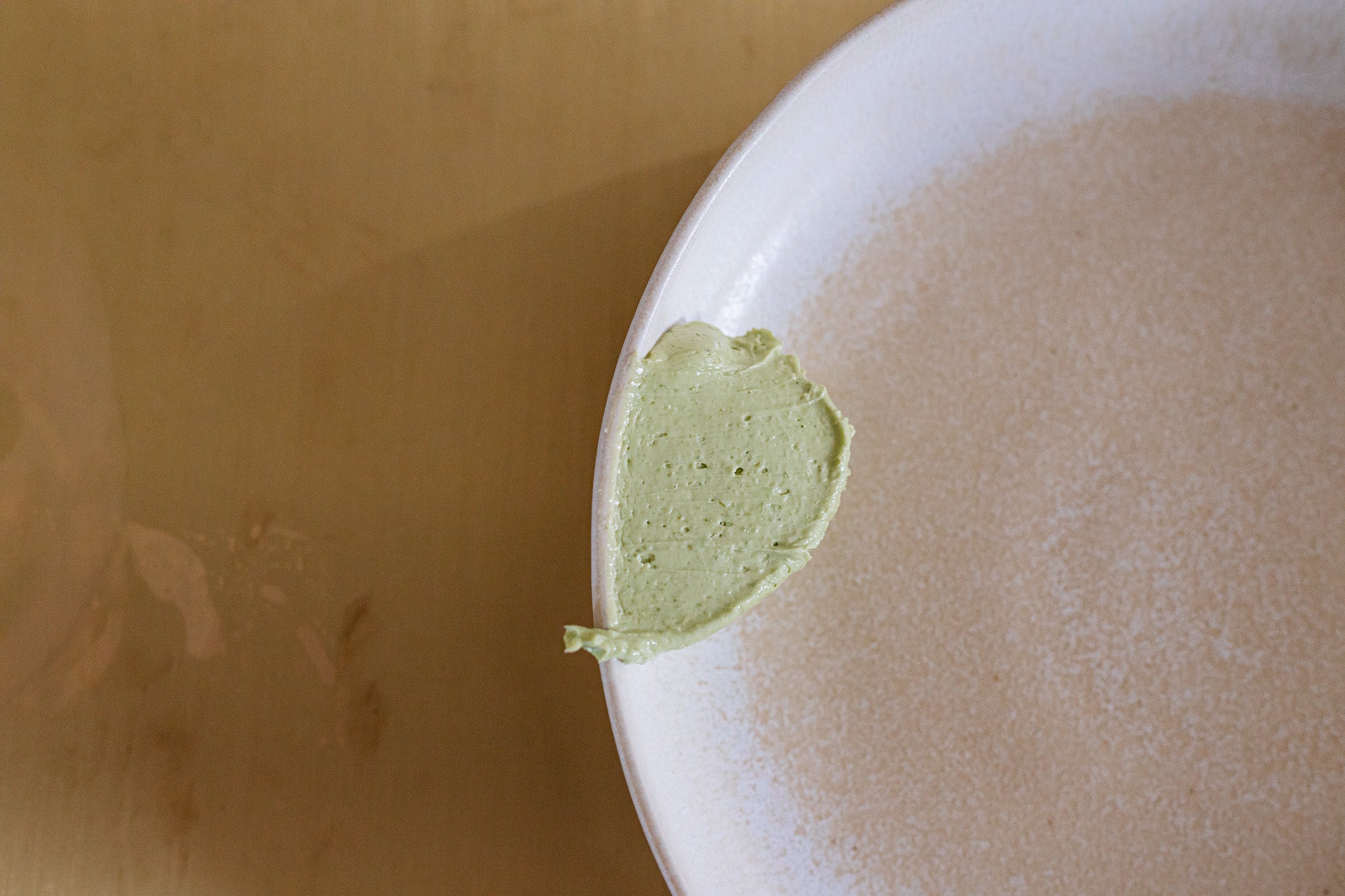 closeup of seasoned butter on the edge of a plate