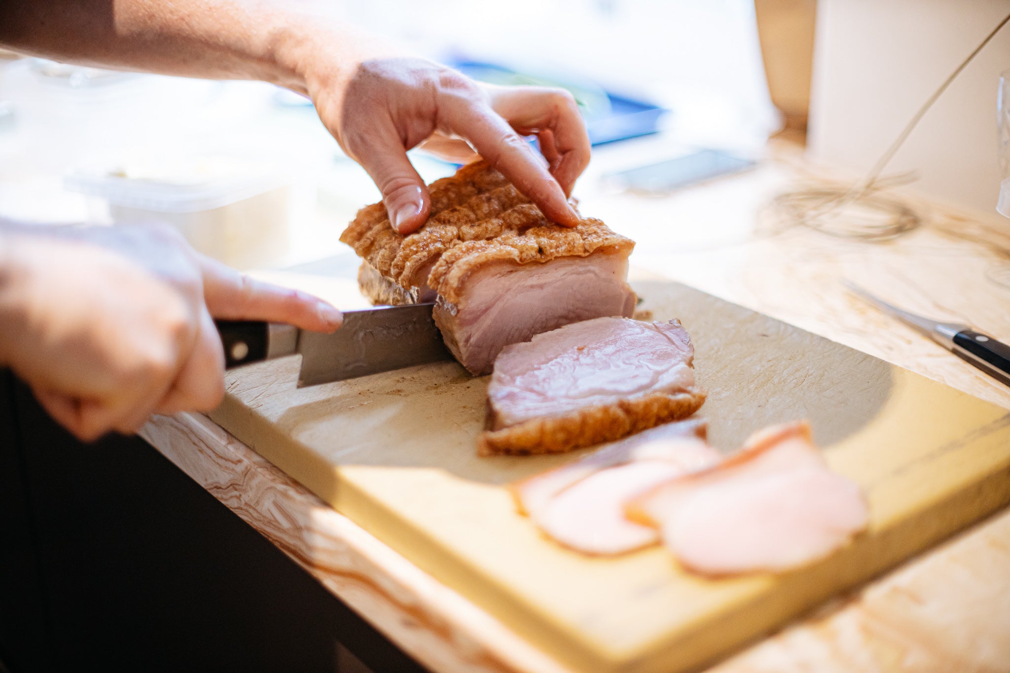 chef slicing pork belly