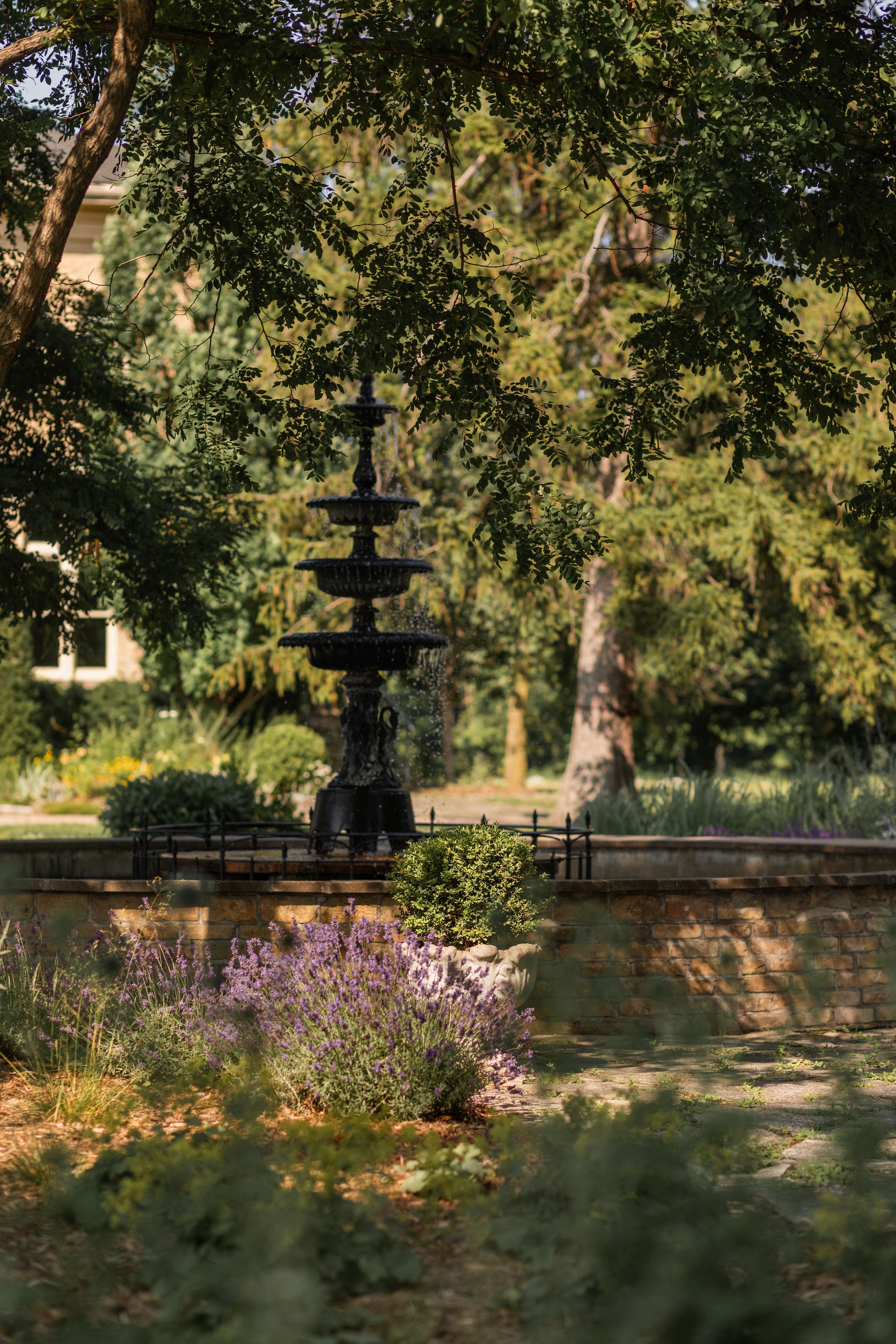 italian style iron fountain in the dappled light