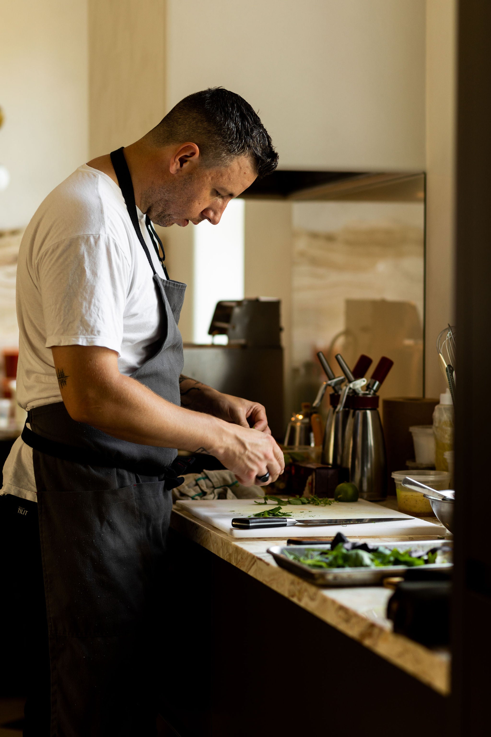 chef Kevin Castonguay preparing food in the kitchen at Lune
