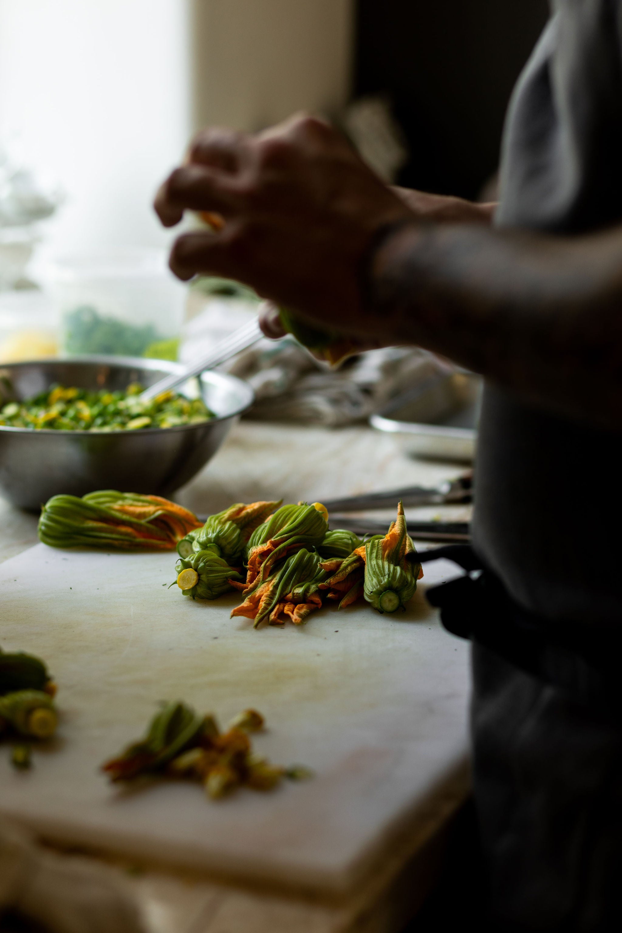 closeup of squash blossoms being prepared