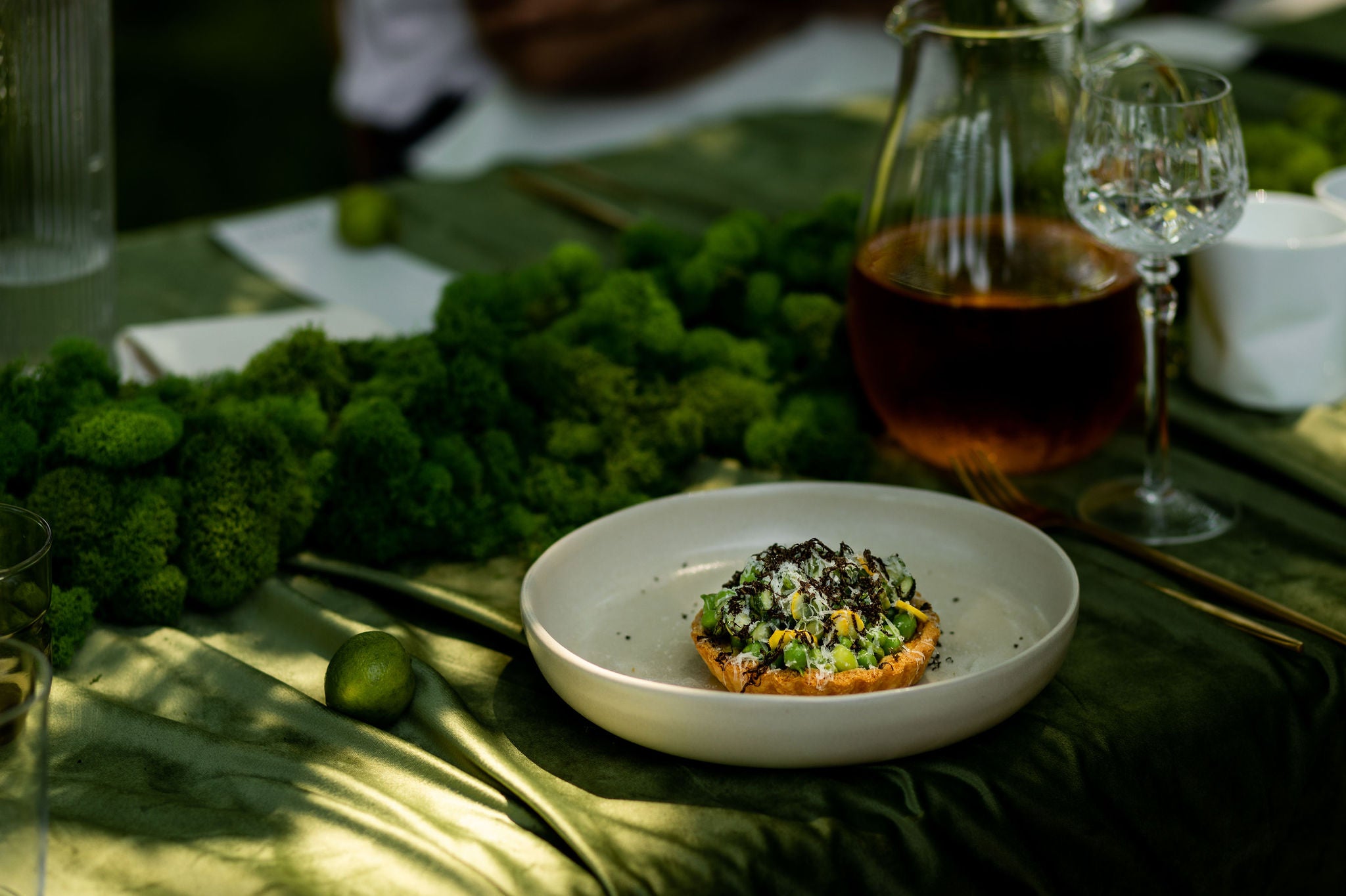 closeup of meal on plate, green velvet tablecloth